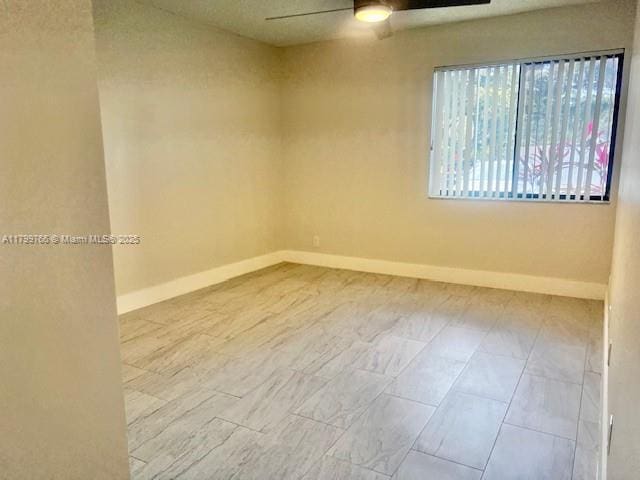 9920 NW 68th Pl Unit 103, Tamarac, FL 33321 - empty room with ceiling fan and baseboards