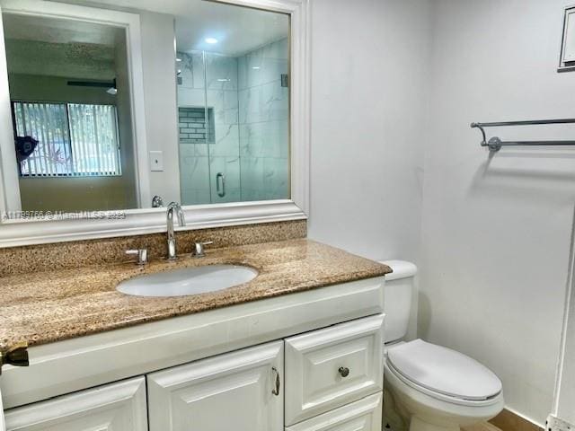 9920 NW 68th Pl Unit 103, Tamarac, FL 33321 - bathroom featuring a stall shower, toilet, and vanity