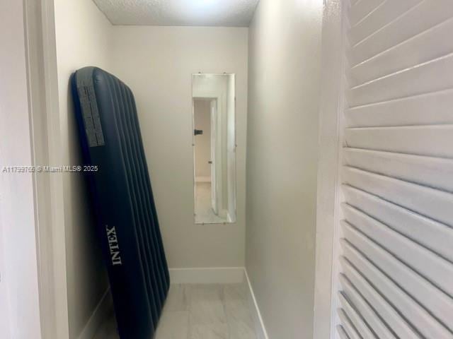 9920 NW 68th Pl Unit 103, Tamarac, FL 33321 - hall with baseboards and light marble finish floors