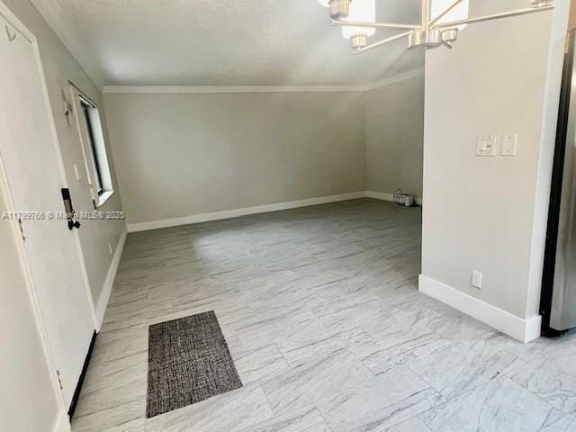 9920 NW 68th Pl Unit 103, Tamarac, FL 33321 - unfurnished room with a chandelier, baseboards, and ornamental molding