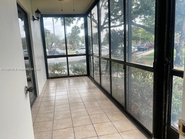 9920 NW 68th Pl Unit 103, Tamarac, FL 33321 - unfurnished sunroom with plenty of natural light