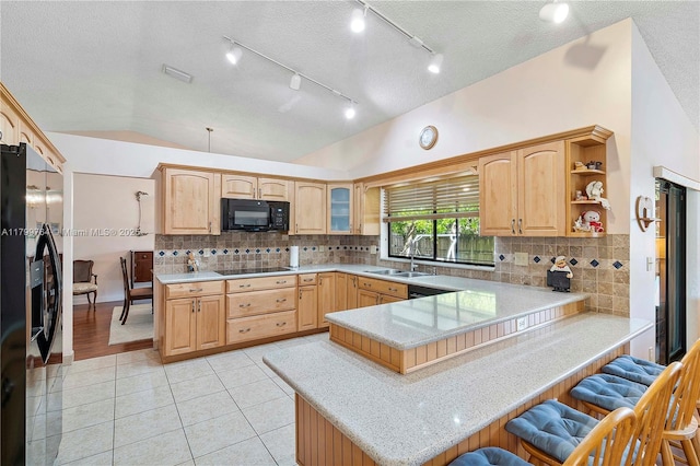 15827 Waverly Mnr, Davie, FL 33331 - kitchen with black appliances, a sink, a breakfast bar, a peninsula, and lofted ceiling