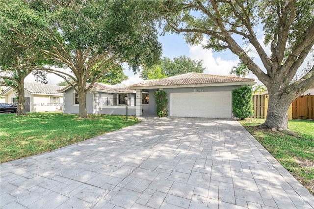 15827 Waverly Mnr, Davie, FL 33331 - single story home with an attached garage, stucco siding, decorative driveway, and a tiled roof