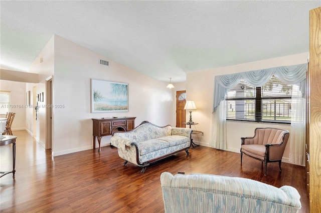 15827 Waverly Mnr, Davie, FL 33331 - living area featuring vaulted ceiling, wood finished floors, baseboards, and a textured ceiling