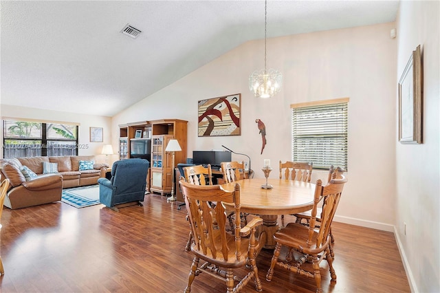 15827 Waverly Mnr, Davie, FL 33331 - dining area with vaulted ceiling, wood finished floors, a chandelier, and baseboards