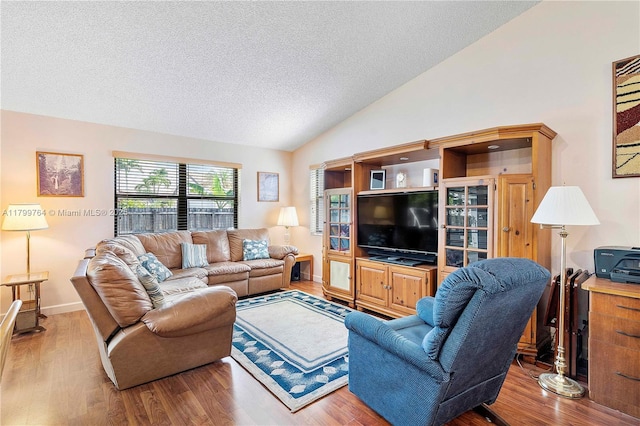 15827 Waverly Mnr, Davie, FL 33331 - living room featuring wood finished floors, a textured ceiling, and vaulted ceiling
