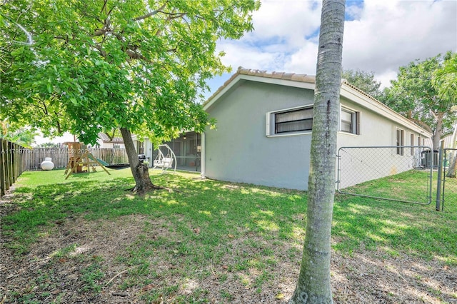 15827 Waverly Mnr, Davie, FL 33331 - back of property featuring stucco siding, a playground, and a gate