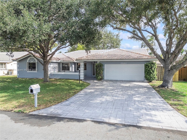 15827 Waverly Mnr, Davie, FL 33331 - ranch-style home with a tiled roof, a garage, stucco siding, and decorative driveway