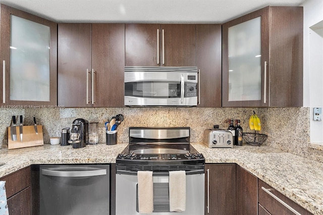 1750 W 46th St Unit 528, Hialeah, FL 33012 - kitchen featuring stainless steel appliances, dark brown cabinets, decorative backsplash, and glass insert cabinets