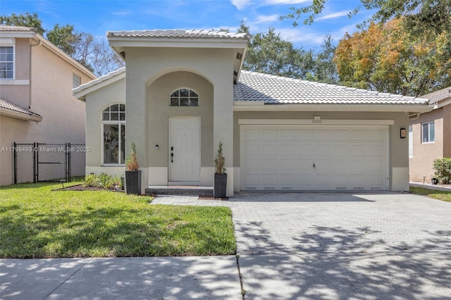 5020 Ibis Ct, Coconut Creek, FL 33073 - mediterranean / spanish home with stucco siding, an attached garage, driveway, and a tiled roof