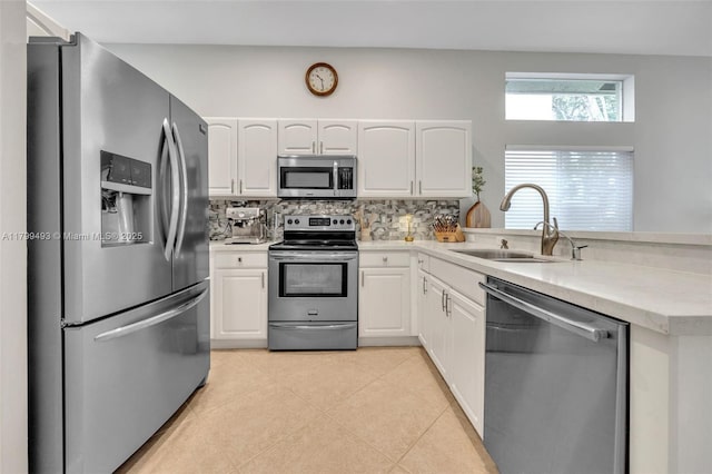 5020 Ibis Ct, Coconut Creek, FL 33073 - kitchen featuring appliances with stainless steel finishes, a sink, a peninsula, and white cabinetry