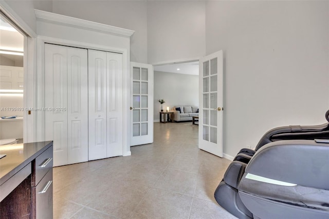 5020 Ibis Ct, Coconut Creek, FL 33073 - exercise area with french doors, a towering ceiling, light tile patterned floors, and baseboards