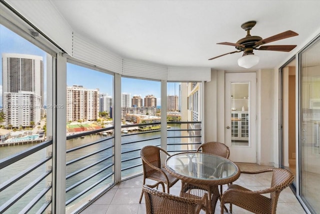 100 Golden Isles Dr Unit 1105, Hallandale Beach, FL 33009 - sunroom with a water view, tile patterned flooring, ceiling fan, and a view of city