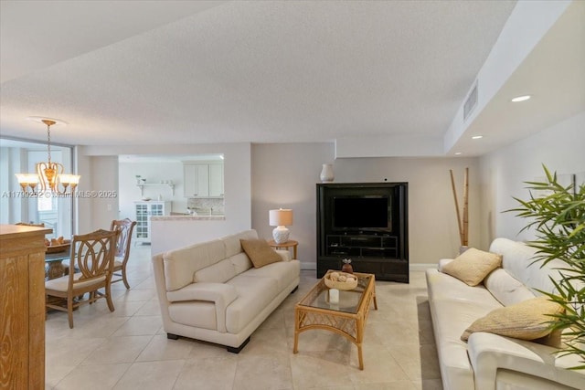 100 Golden Isles Dr Unit 1105, Hallandale Beach, FL 33009 - living area featuring a chandelier, light tile patterned floors, a textured ceiling, and recessed lighting