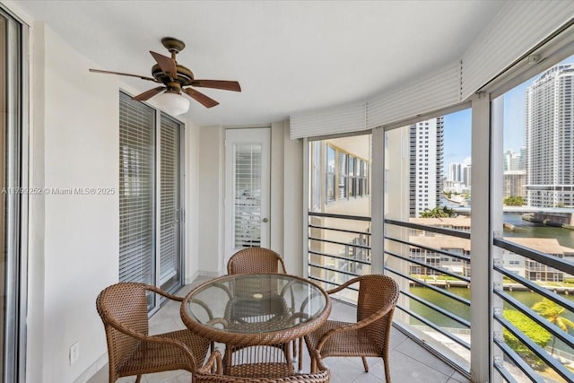 100 Golden Isles Dr Unit 1105, Hallandale Beach, FL 33009 - sunroom / solarium with a water view, a ceiling fan, tile patterned floors, and a city view