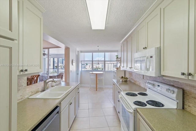 100 Golden Isles Dr Unit 1105, Hallandale Beach, FL 33009 - kitchen with white appliances, decorative backsplash, a sink, a textured ceiling, and light countertops