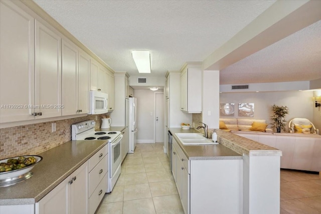 100 Golden Isles Dr Unit 1105, Hallandale Beach, FL 33009 - kitchen with white appliances, a sink, open floor plan, decorative backsplash, and light tile patterned floors