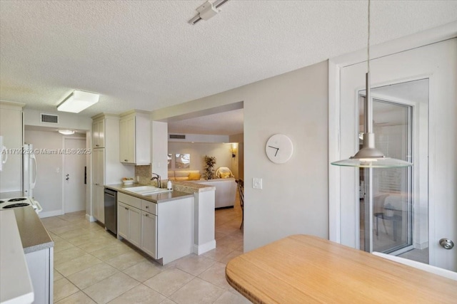 100 Golden Isles Dr Unit 1105, Hallandale Beach, FL 33009 - kitchen with a sink, stainless steel dishwasher, light tile patterned floors, a textured ceiling, and a peninsula