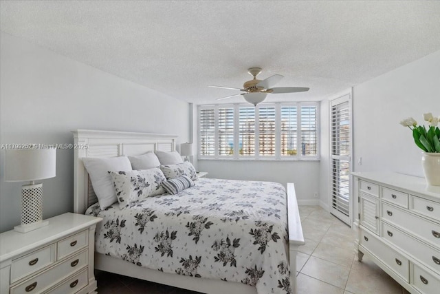 100 Golden Isles Dr Unit 1105, Hallandale Beach, FL 33009 - bedroom featuring light tile patterned floors, a textured ceiling, ceiling fan, and access to exterior