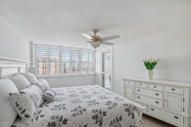100 Golden Isles Dr Unit 1105, Hallandale Beach, FL 33009 - tiled bedroom featuring a textured ceiling, ceiling fan, and access to outside