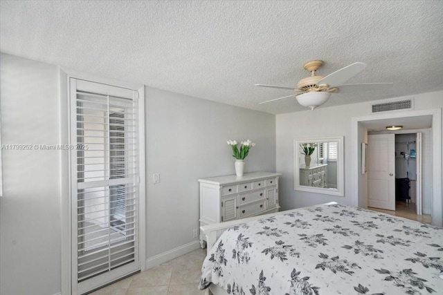 100 Golden Isles Dr Unit 1105, Hallandale Beach, FL 33009 - bedroom with a textured ceiling, light tile patterned floors, ceiling fan, and baseboards