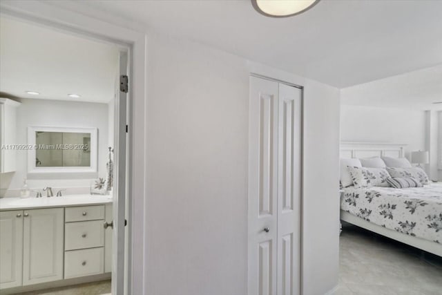100 Golden Isles Dr Unit 1105, Hallandale Beach, FL 33009 - bedroom with connected bathroom, a sink, and a closet