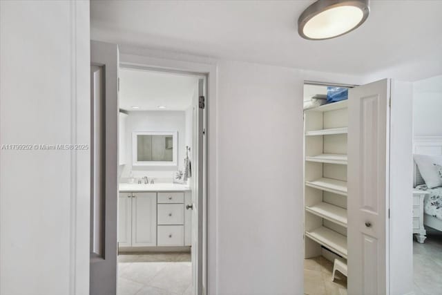100 Golden Isles Dr Unit 1105, Hallandale Beach, FL 33009 - corridor with a sink and light tile patterned flooring