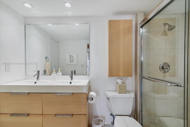 100 Golden Isles Dr Unit 1105, Hallandale Beach, FL 33009 - full bathroom featuring a stall shower, toilet, recessed lighting, and double vanity