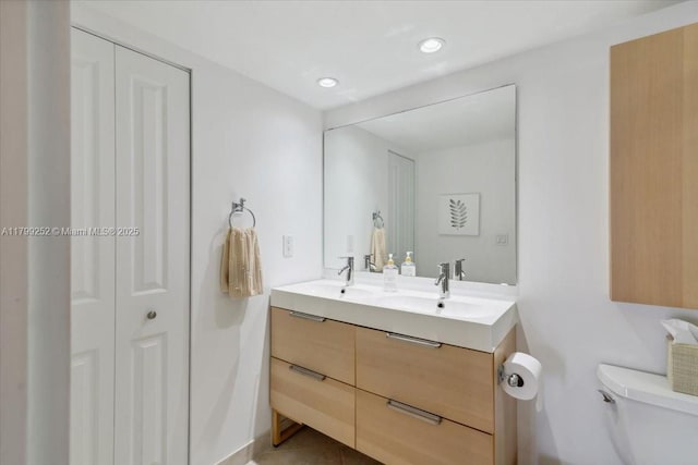 100 Golden Isles Dr Unit 1105, Hallandale Beach, FL 33009 - full bathroom featuring toilet, double vanity, and recessed lighting