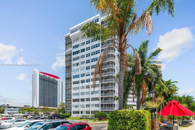 100 Golden Isles Dr Unit 1105, Hallandale Beach, FL 33009 - view of building exterior with uncovered parking