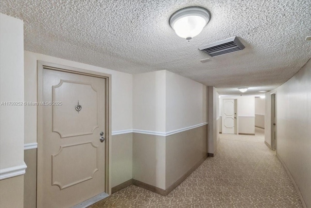 100 Golden Isles Dr Unit 1105, Hallandale Beach, FL 33009 - hallway featuring baseboards and a textured ceiling