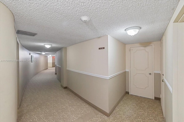 100 Golden Isles Dr Unit 1105, Hallandale Beach, FL 33009 - corridor featuring baseboards and a textured ceiling