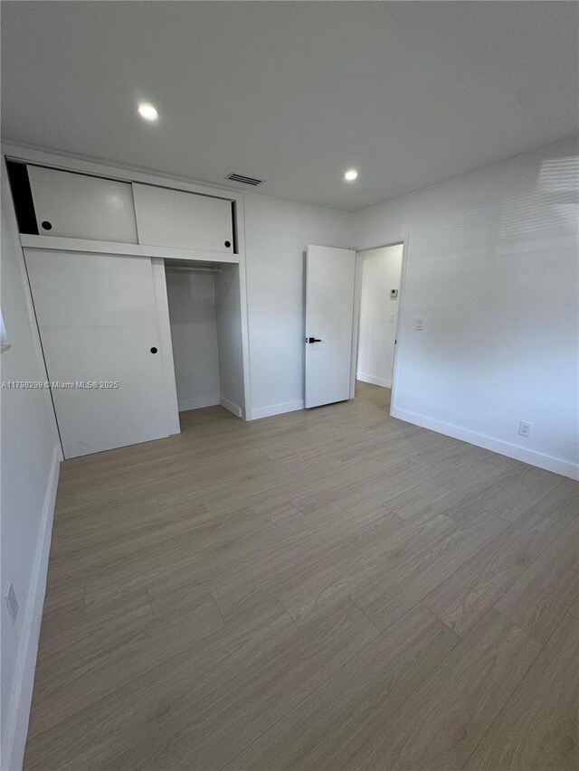 421 SW 11th Ave, Hallandale Beach, FL 33009 - unfurnished bedroom featuring baseboards, recessed lighting, and a closet