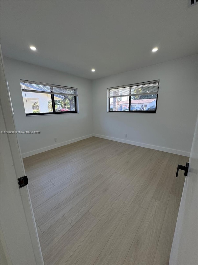 421 SW 11th Ave, Hallandale Beach, FL 33009 - unfurnished room with recessed lighting, light wood-style floors, and baseboards
