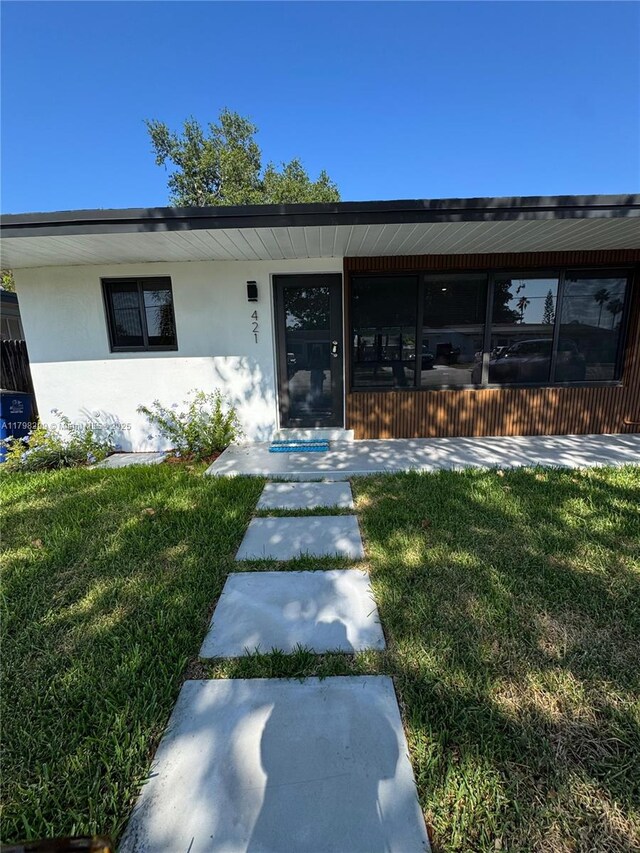 421 SW 11th Ave, Hallandale Beach, FL 33009 - view of front of house with stucco siding and a front yard