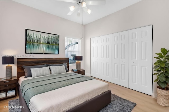 bedroom with light wood-style floors, a closet, and a ceiling fan