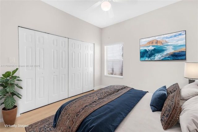 bedroom with a closet, ceiling fan, and wood finished floors
