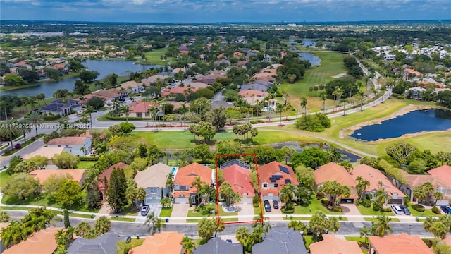 aerial perspective of suburban area with property boundaries highlighted, a large body of water, and a golf club