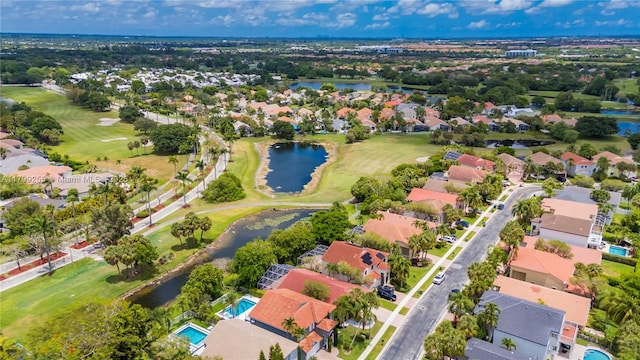 aerial perspective of suburban area with a golf club and a nearby body of water