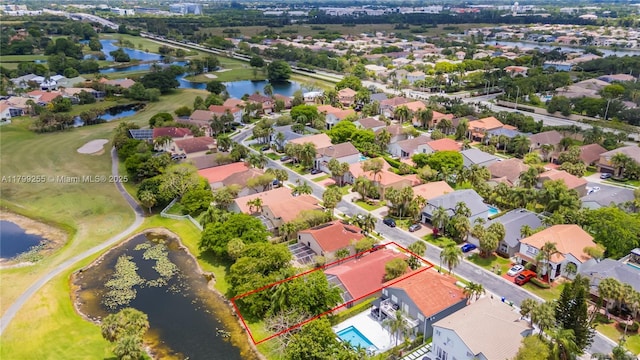 aerial perspective of suburban area with property parcel outlined, a nearby body of water, and a golf club