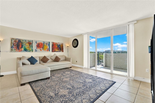 2750 NE 183rd St Unit 504, Aventura, FL 33160 - living room featuring floor to ceiling windows, light tile patterned floors, a textured ceiling, and baseboards
