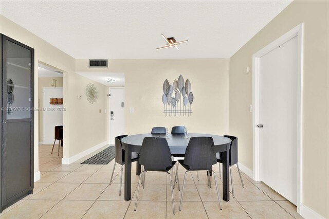 2750 NE 183rd St Unit 504, Aventura, FL 33160 - dining space with light tile patterned flooring and baseboards
