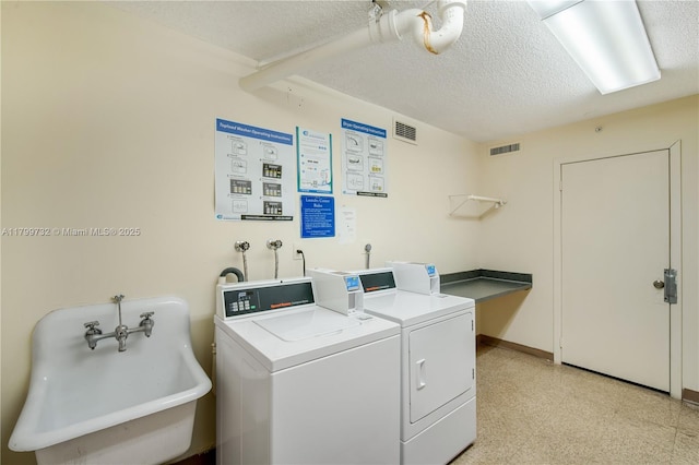 2750 NE 183rd St Unit 504, Aventura, FL 33160 - shared laundry featuring washing machine and dryer, a textured ceiling, light flooring, and baseboards