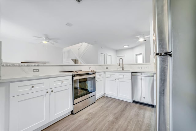 16818 SW 1st Mnr, Pembroke Pines, FL 33027 - kitchen with appliances with stainless steel finishes, ceiling fan, a sink, and white cabinetry