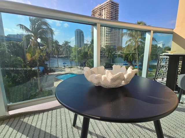 balcony featuring view of pool area