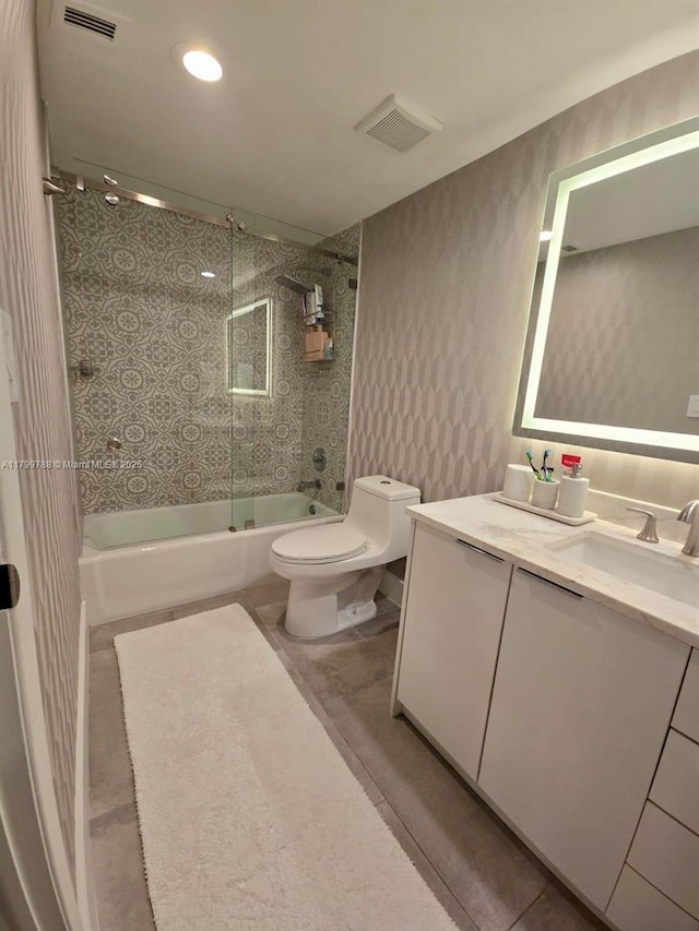 bathroom with toilet, shower / washtub combination, vanity, tile patterned flooring, and recessed lighting