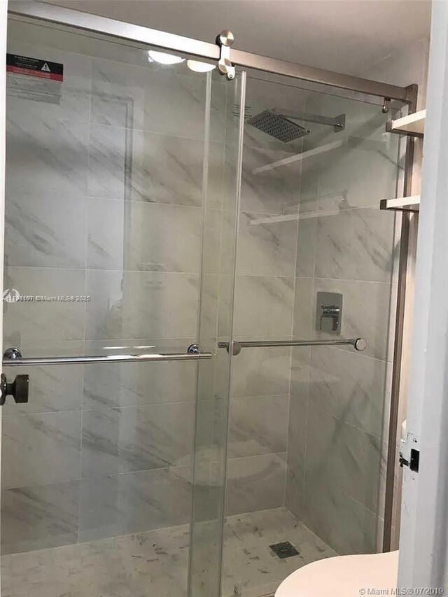 bathroom with a shower stall