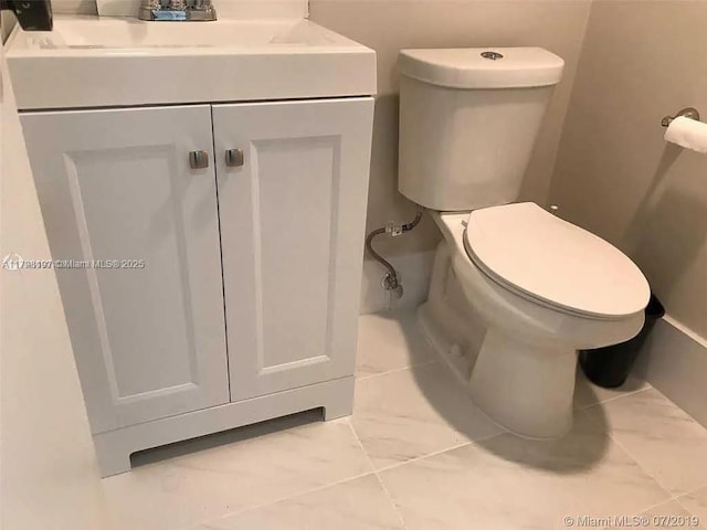 half bath featuring toilet and vanity