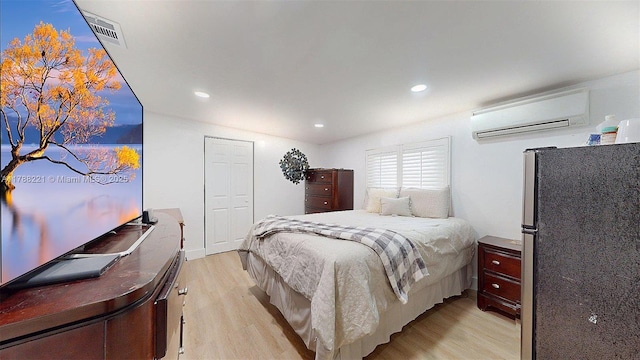 5010 SW 111th Ave, Miami, FL 33165 - bedroom with freestanding refrigerator, a wall unit AC, light wood-style flooring, and recessed lighting