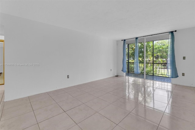 7300 NW 17th St Unit 203, Plantation, FL 33313 - unfurnished room featuring a wall of windows and light tile patterned flooring